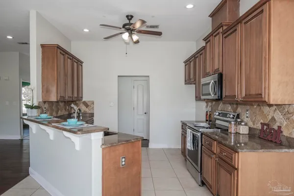 a kitchen with a stove sink and cabinets