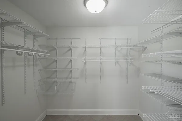 a bathroom with a granite countertop bathtub a sink and a mirror