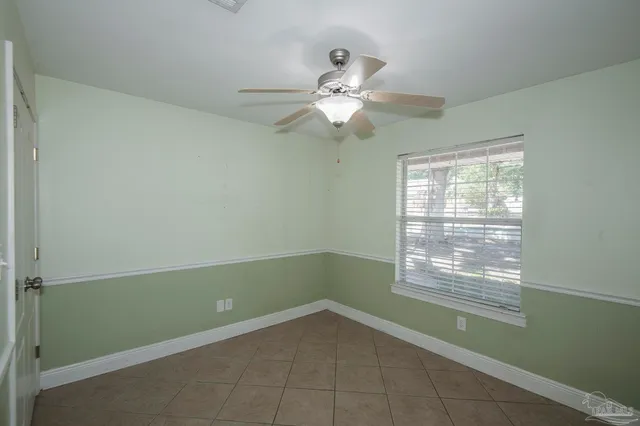 a living room with a ceiling fan and a window