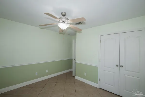 a view of a room that has a fan and a window