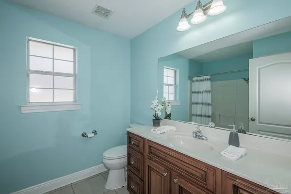 a view of a big room with wooden floor and windows