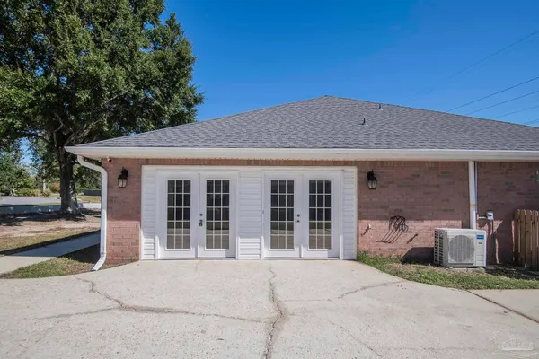 a view of a yard in front of a house with large tree