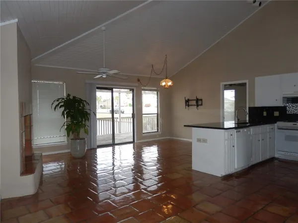 a kitchen with a white counter top and natural light