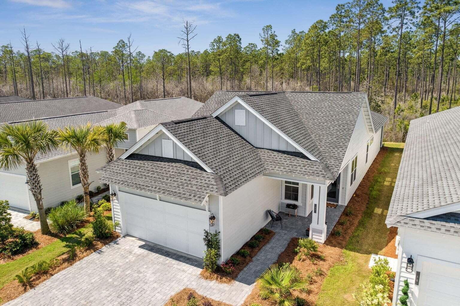 92 East Lafayette Rd Inlet Beach Inlet Beach, FL 32461 - Photo 35 of 51 a view of a house with a bed and trees in the background