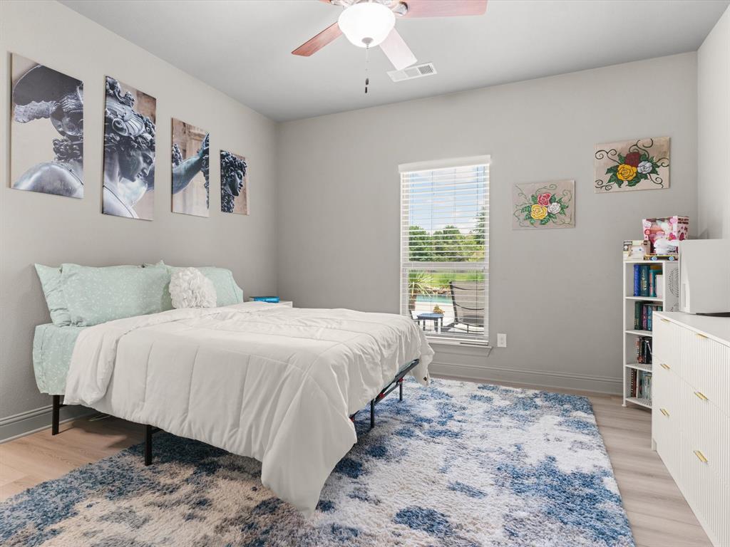 111 Old Base Road Aurora, TX 76078 - Photo 21 of 38 Comfortable secondary bedroom with updated lighting and ample closet space.