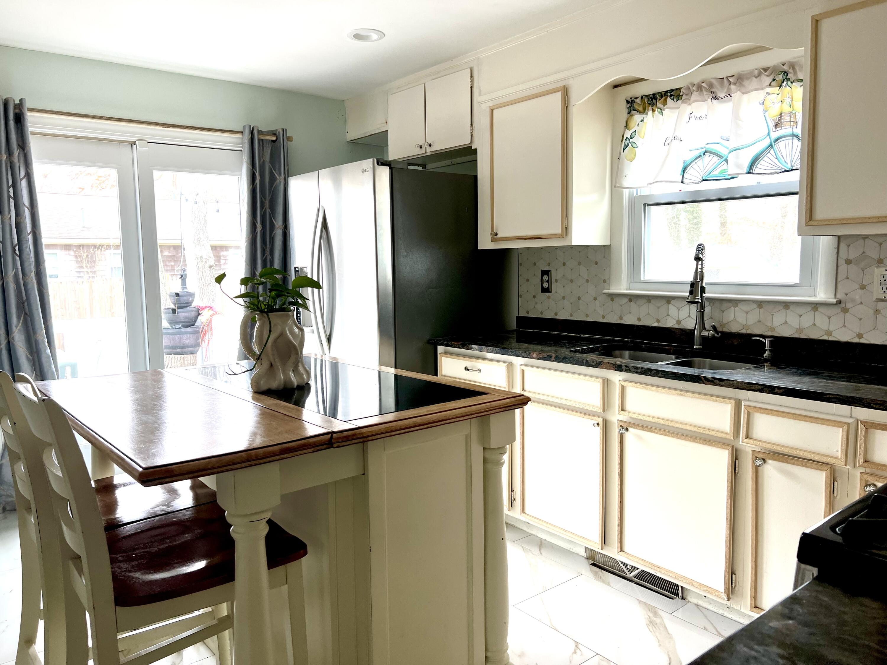 140 Mitchells Way Hyannis, MA 02601 - Photo 11 of 45 a kitchen with stainless steel appliances a sink and a large window