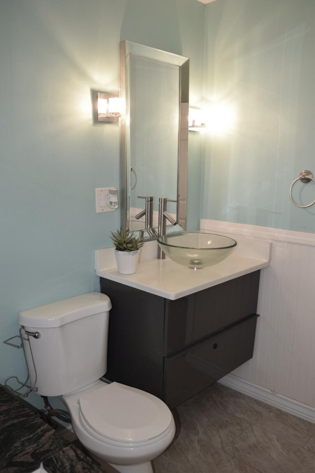 140 Mitchells Way Hyannis, MA 02601 - Photo 22 of 45 a bathroom with a sink mirror vanity and toilet