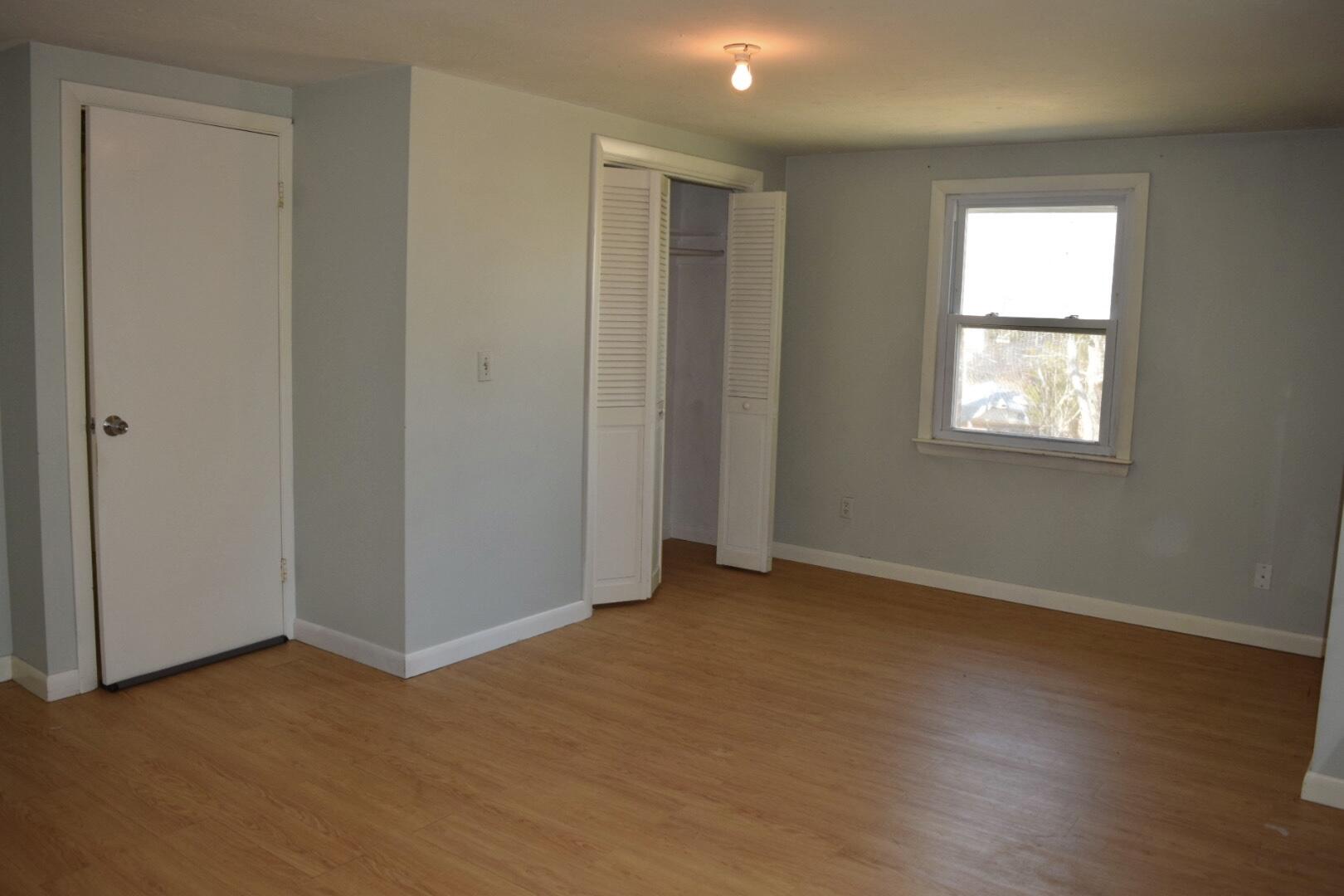 140 Mitchells Way Hyannis, MA 02601 - Photo 36 of 45 an empty room with wooden floor and windows