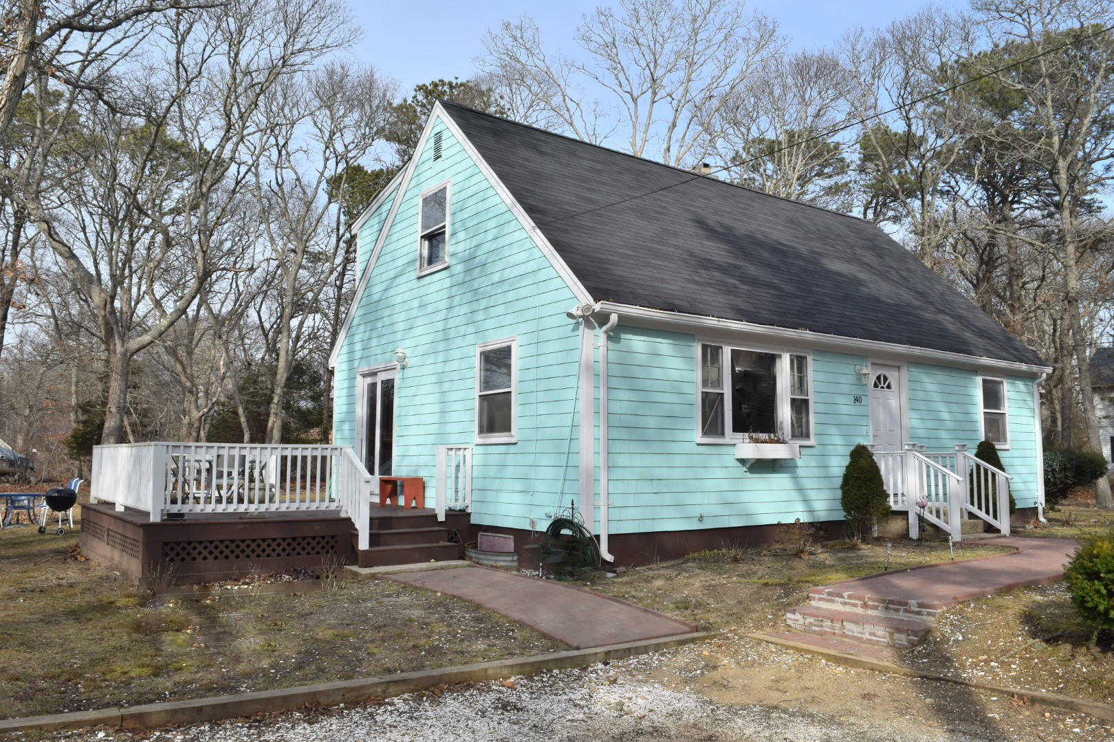 140 Mitchells Way Hyannis, MA 02601 - Photo 39 of 45 a view of a house with a yard chairs and wooden fence