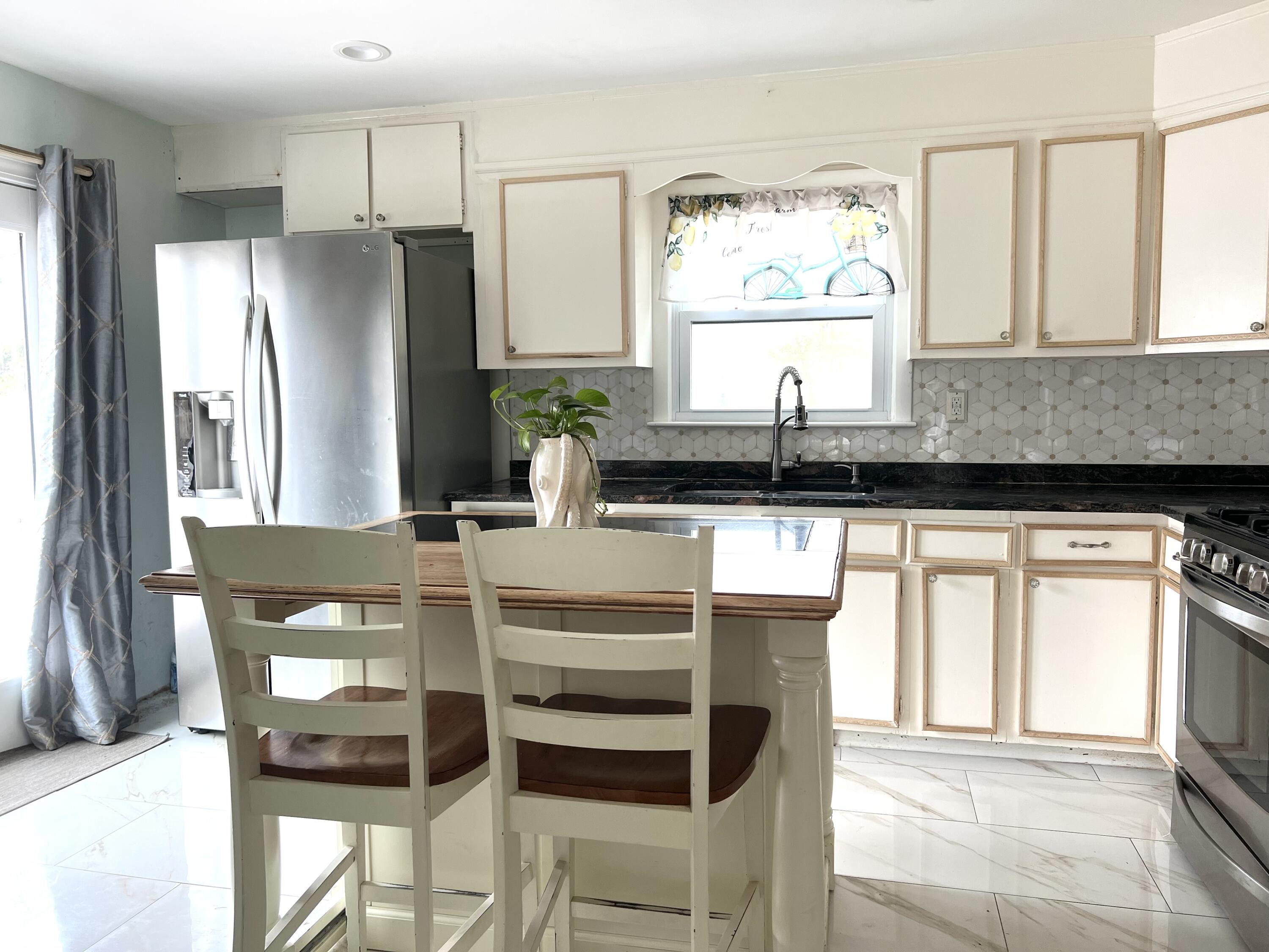 140 Mitchells Way Hyannis, MA 02601 - Photo 10 of 45 a kitchen with granite countertop a refrigerator and a stove top oven