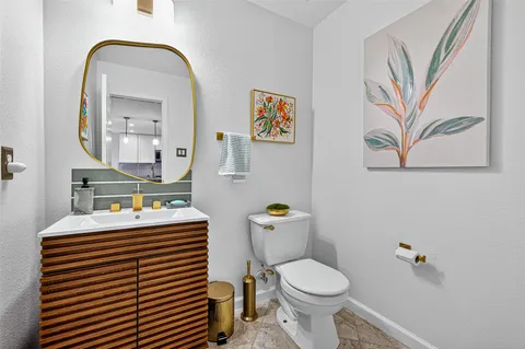 a bathroom with a sink mirror and toilet