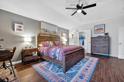 a bedroom with a bed and wooden floor