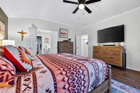 a bedroom with bed and flat screen tv