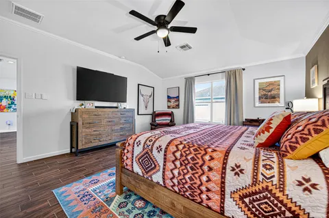 a bedroom with a bed and a flat screen tv