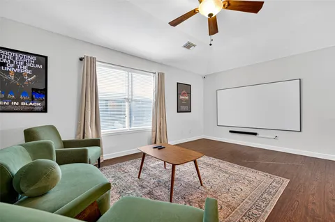 a living room with furniture and wooden floor