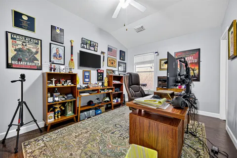 a view of a workspace with furniture and a window