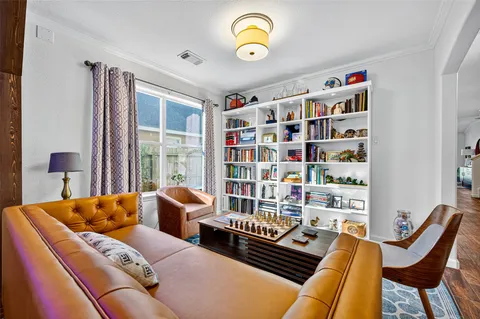 a living room with furniture a rug and a window