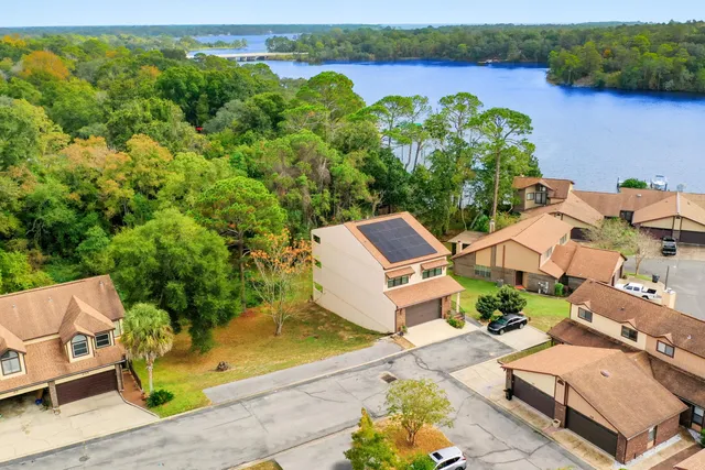 an aerial view of a house with garden space and lake view