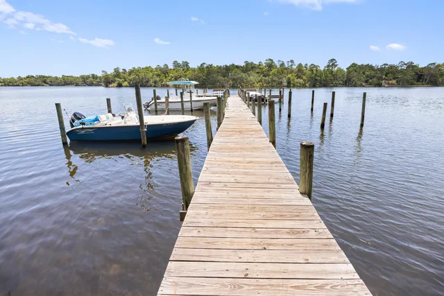a view of a lake with boats and trees in the background
