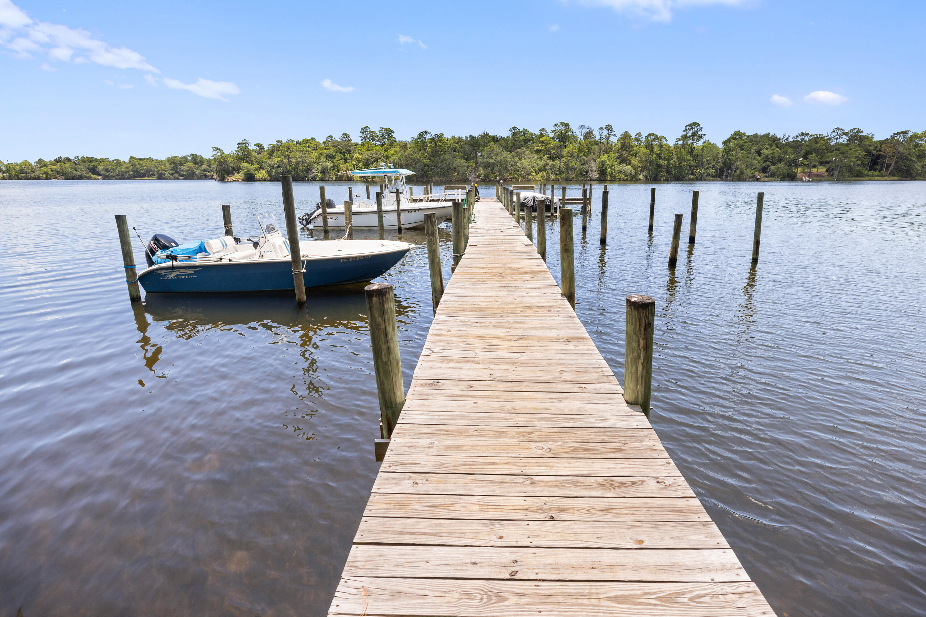 25 Hidden Cove Circle Valparaiso, FL 32580 - Photo 5 of 13 a view of a lake with boats and trees in the background