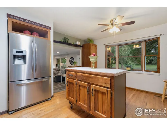 a kitchen with stainless steel appliances granite countertop a refrigerator a sink and a stove