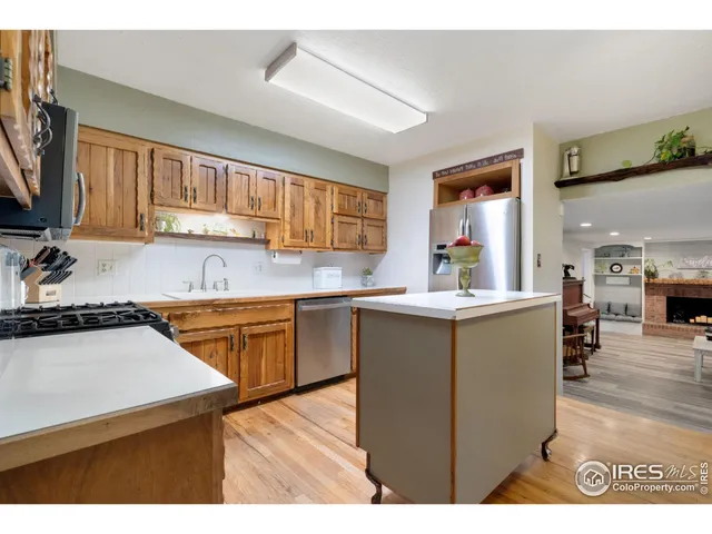 a kitchen with granite countertop a sink stove and cabinets