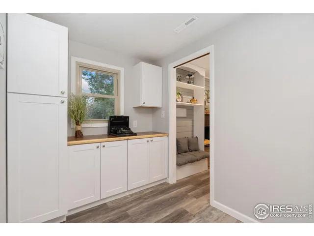 a kitchen with a refrigerator and a window