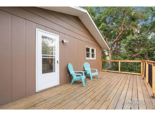 a balcony with wooden floor and furniture