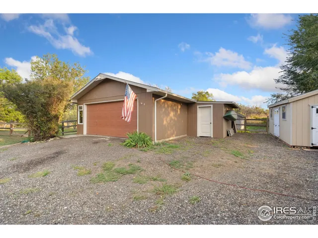 a view of a house with a yard and garage