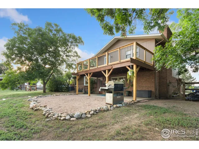 a view of a backyard with sitting area