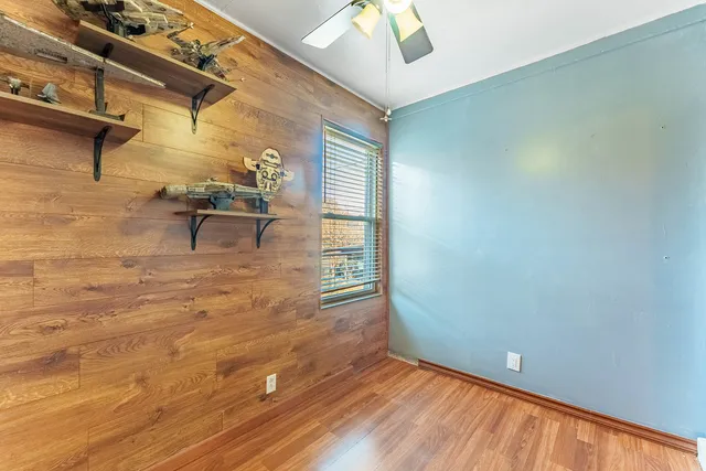 a view of room with window and wooden floor