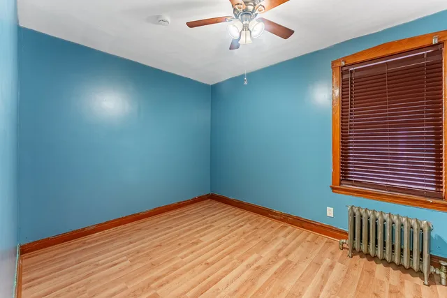 a view of a room with a window and ceiling fan