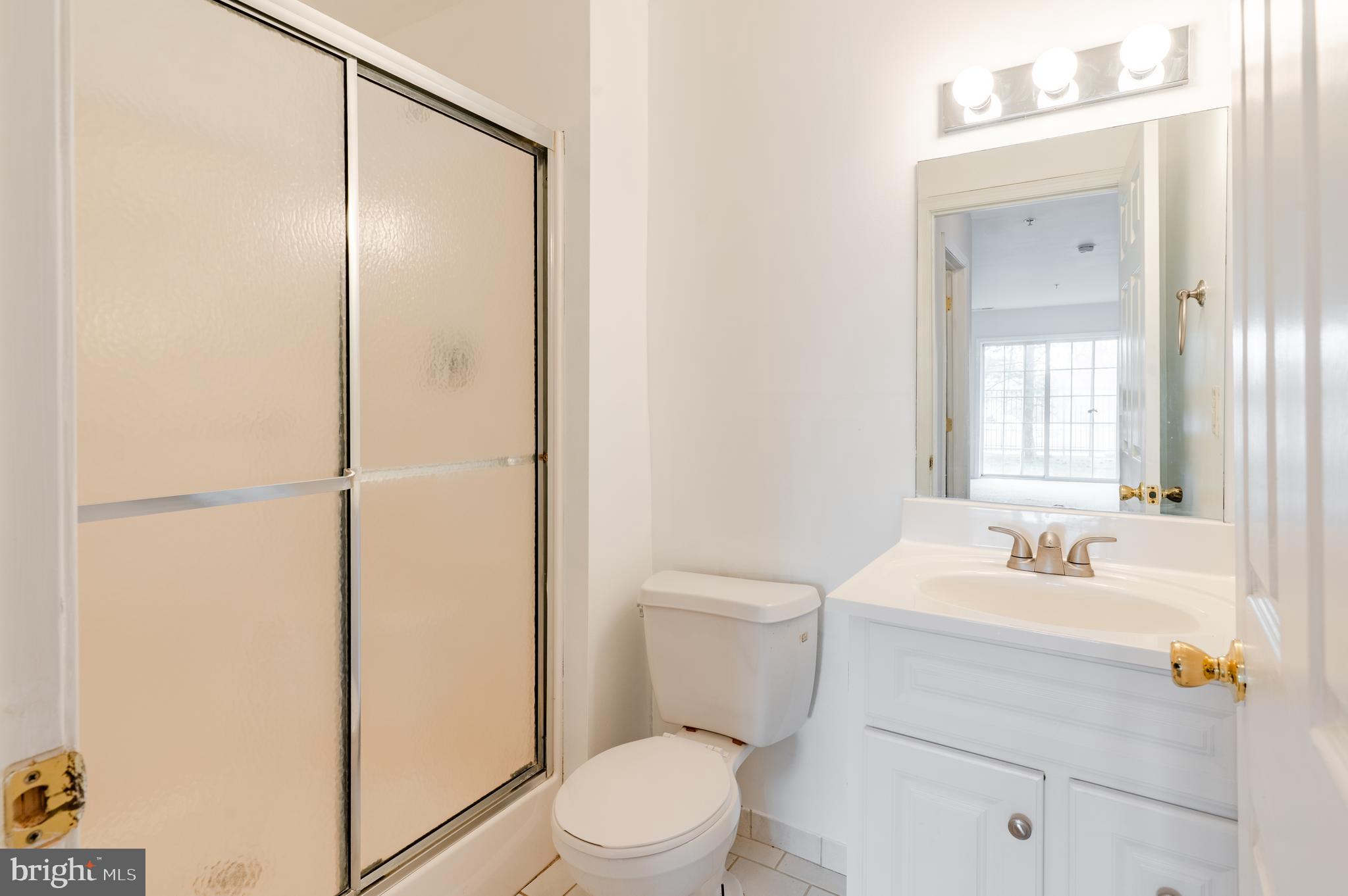 9228 Blue Grass Road, Unit 39 Philadelphia, PA 19114 - Photo 12 of 21 a bathroom with a sink a toilet and shower
