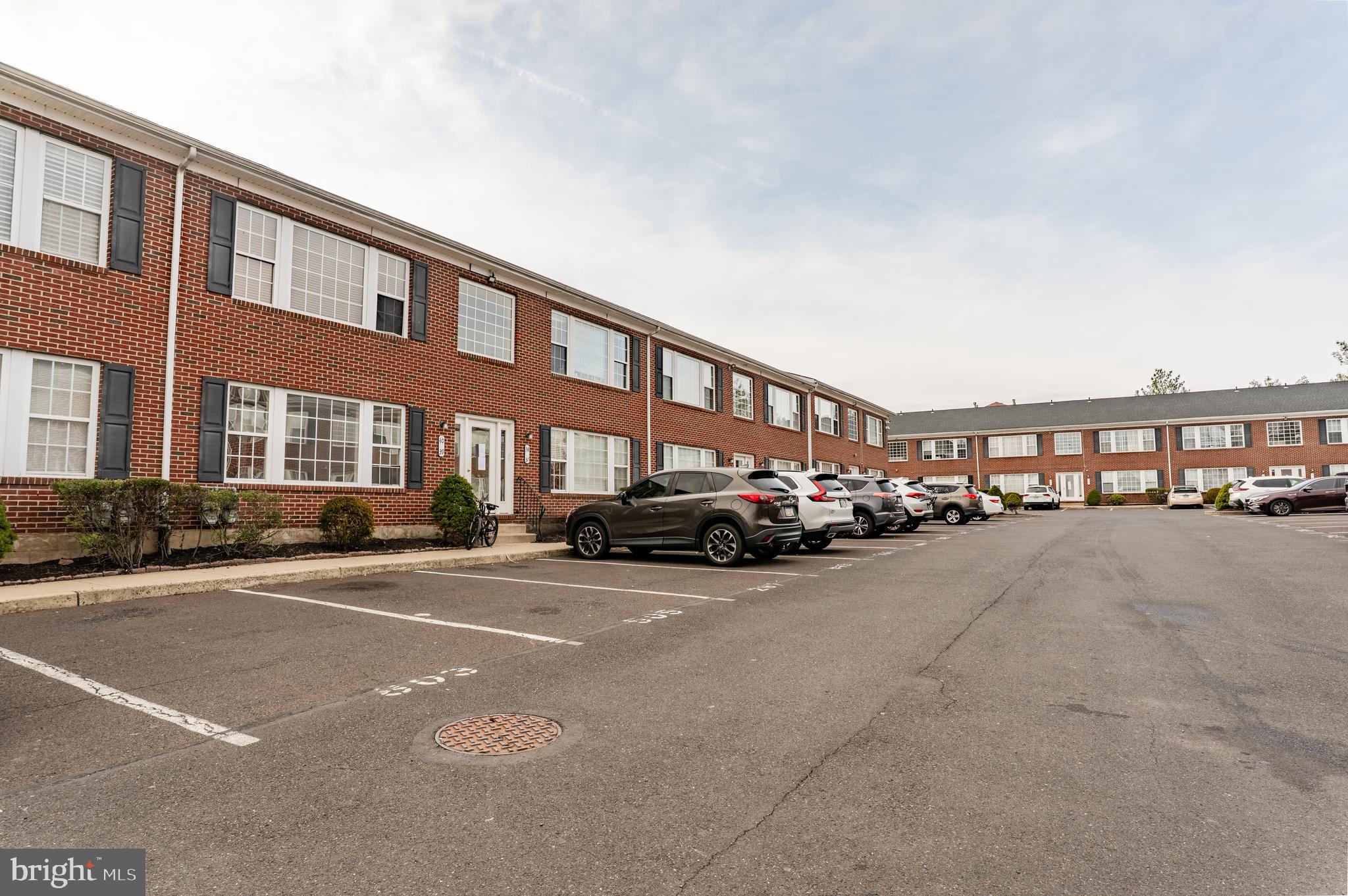 9228 Blue Grass Road, Unit 39 Philadelphia, PA 19114 - Photo 20 of 21 a couple of cars parked in front of a building