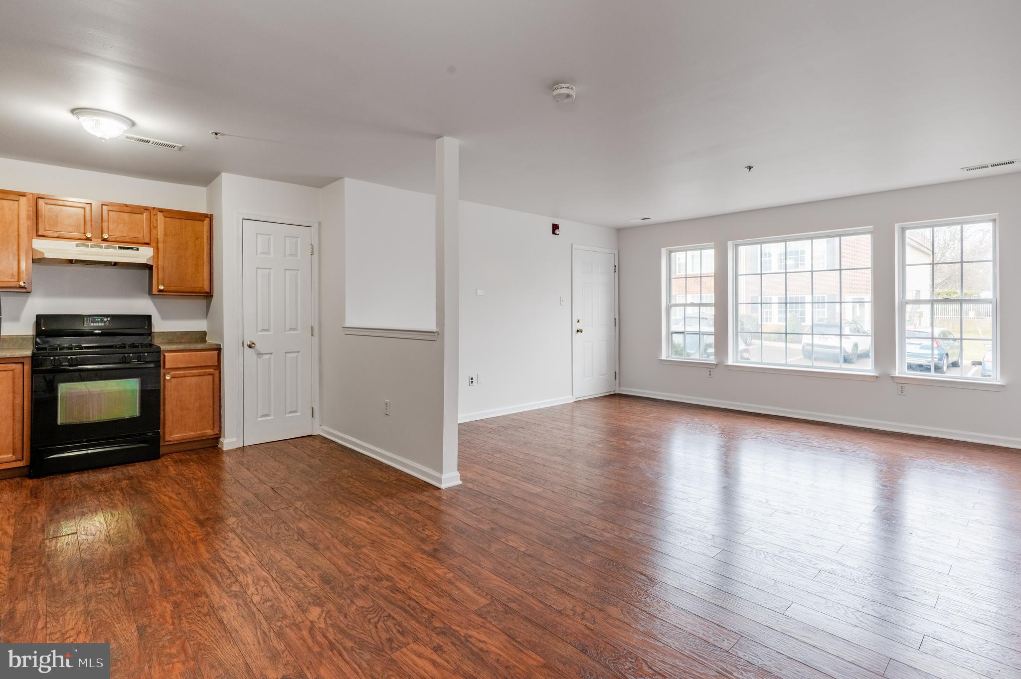 9228 Blue Grass Road, Unit 39 Philadelphia, PA 19114 - Photo 4 of 21 an empty room with wooden floor closet and windows