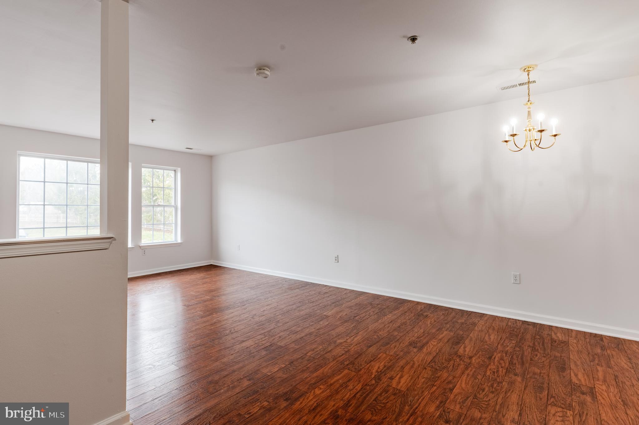9228 Blue Grass Road, Unit 39 Philadelphia, PA 19114 - Photo 5 of 21 wooden floor in an empty room with a window