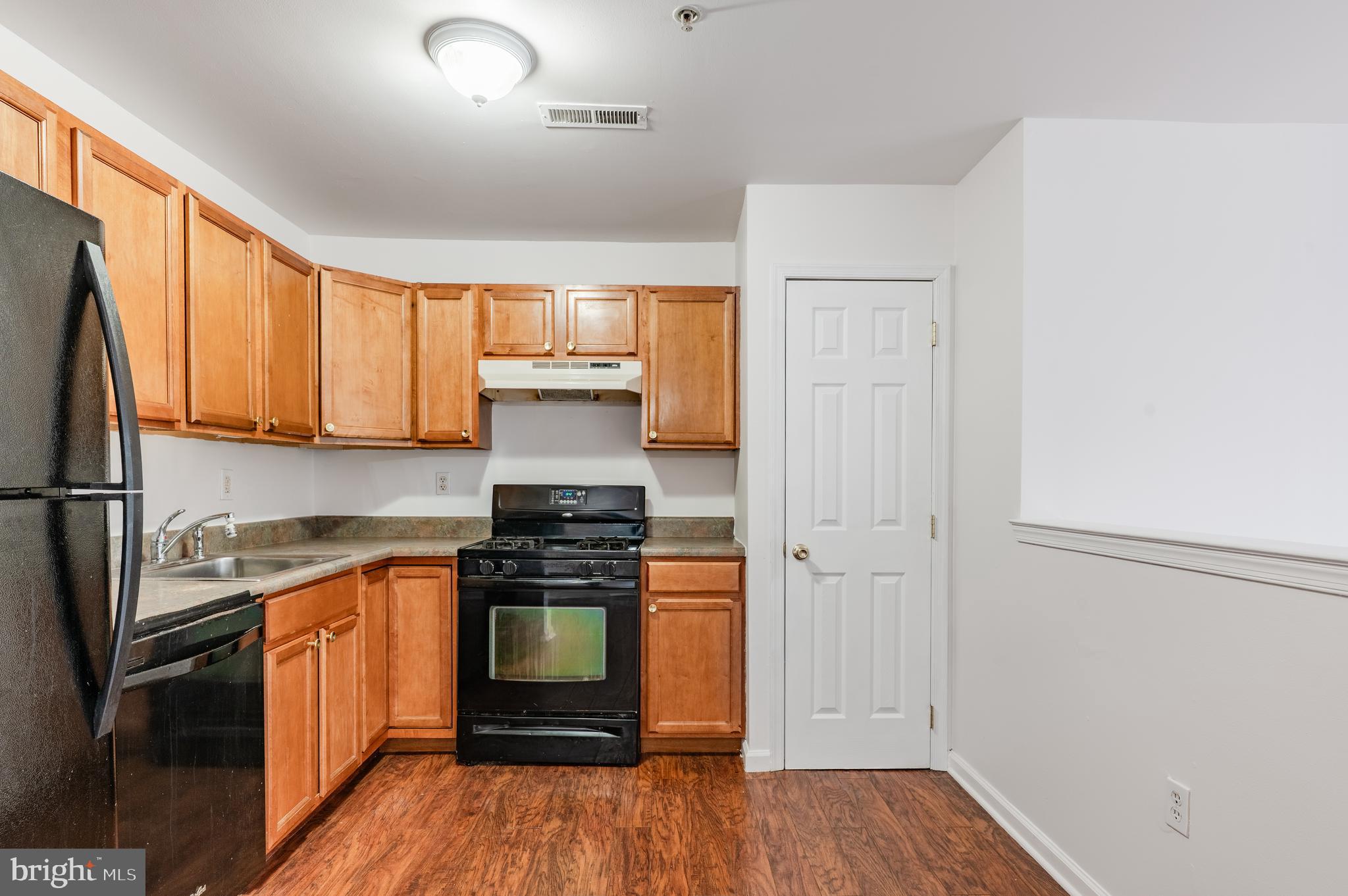 9228 Blue Grass Road, Unit 39 Philadelphia, PA 19114 - Photo 8 of 21 a kitchen with stainless steel appliances a stove sink and refrigerator