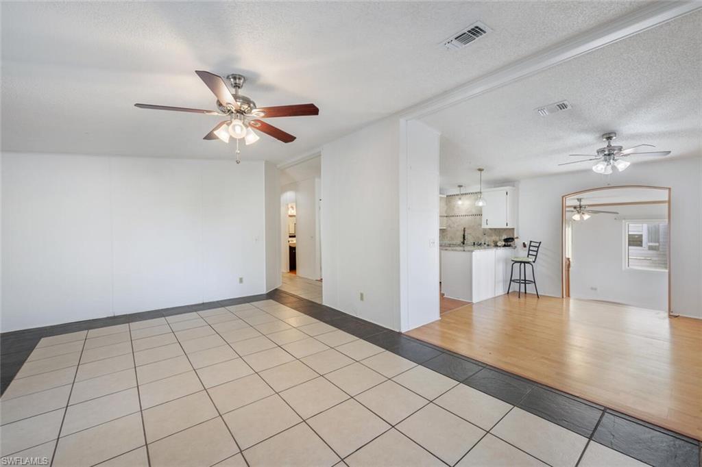 128 Mediterranean Way, Unit 128 Naples, FL 34104 - Photo 11 of 41 Tiled living room and dining room