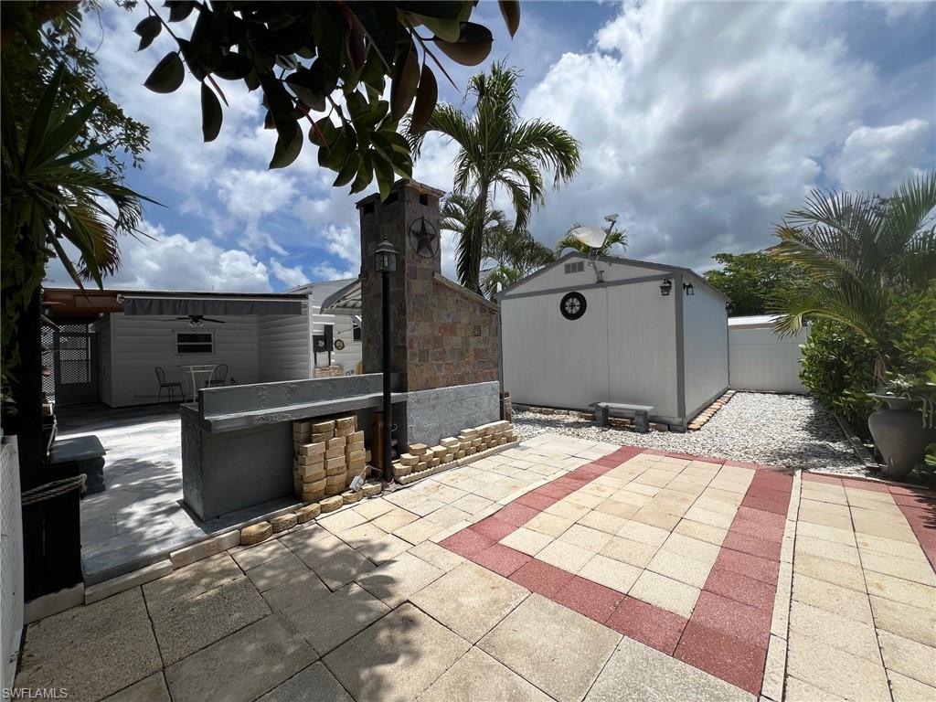 128 Mediterranean Way, Unit 128 Naples, FL 34104 - Photo 32 of 41 View of yard featuring a gate