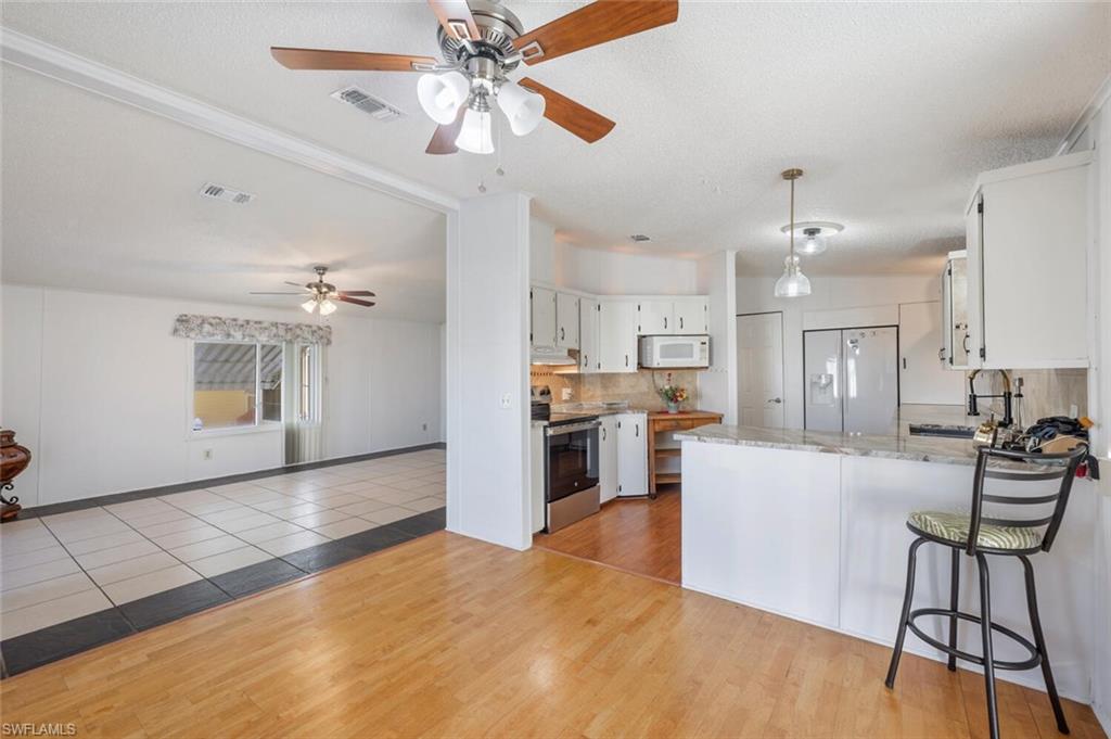 128 Mediterranean Way, Unit 128 Naples, FL 34104 - Photo 6 of 41 Dining area with wood flooring