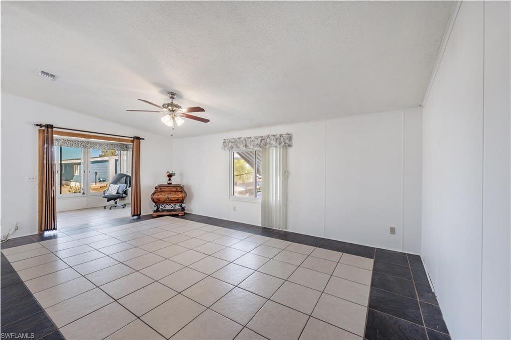 128 Mediterranean Way, Unit 128 Naples, FL 34104 - Photo 9 of 41 Spacious tiled Living Room