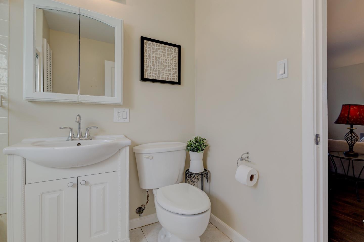 263 Clarendon Road Pacifica, CA 94044 - Photo 14 of 36 a bathroom with a toilet sink and mirror