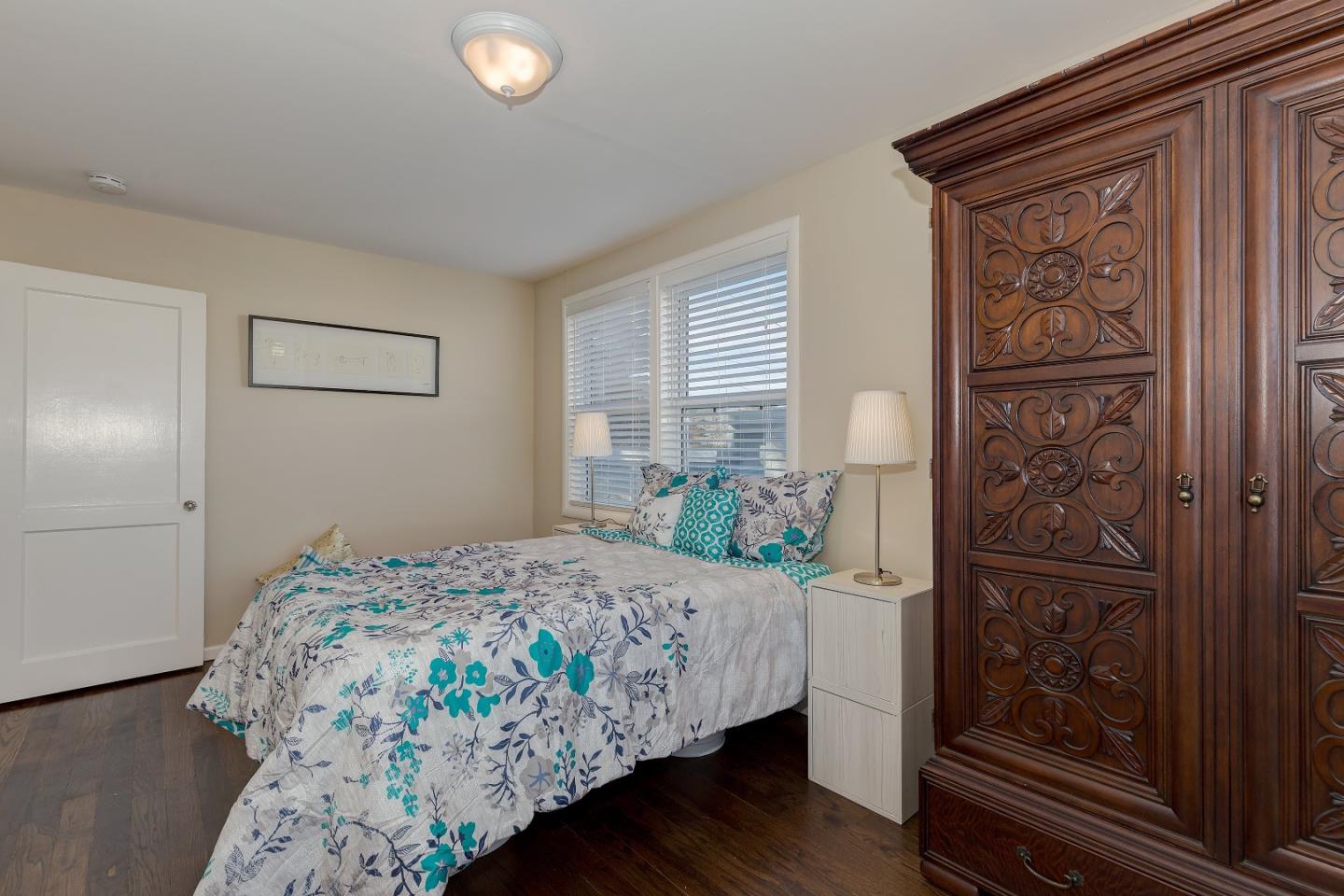 263 Clarendon Road Pacifica, CA 94044 - Photo 17 of 36 a bedroom with a bed and a mirror