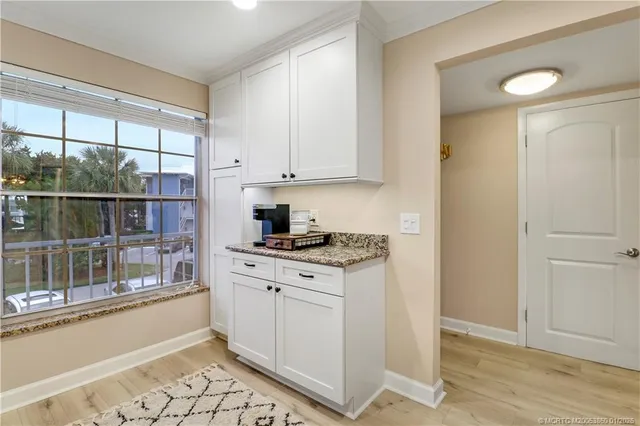 a kitchen with a stove and white cabinets