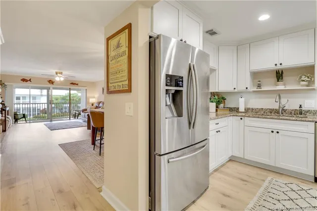 a kitchen with stainless steel appliances a refrigerator sink and cabinets