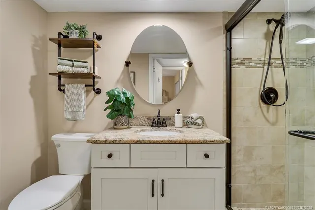 a bathroom with a sink vanity mirror and toilet