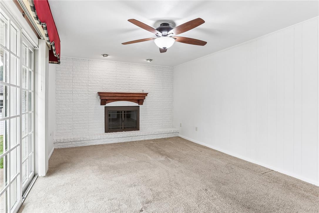 3659 Ironstone Road Bethlehem, PA 18020 - Photo 23 of 52 A cozy living space features a white brick fireplace and direct outdoor access through French doors.