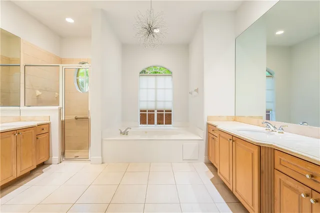 a bathroom with a granite countertop sink a large mirror and a bathtub