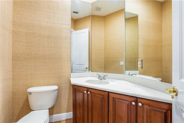 a bathroom with a sink a toilet and mirror