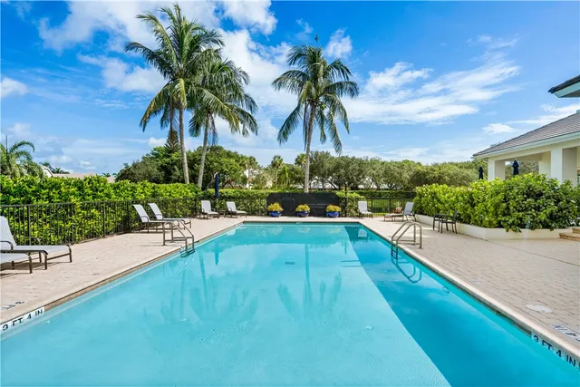 a view of swimming pool with a table and chairs